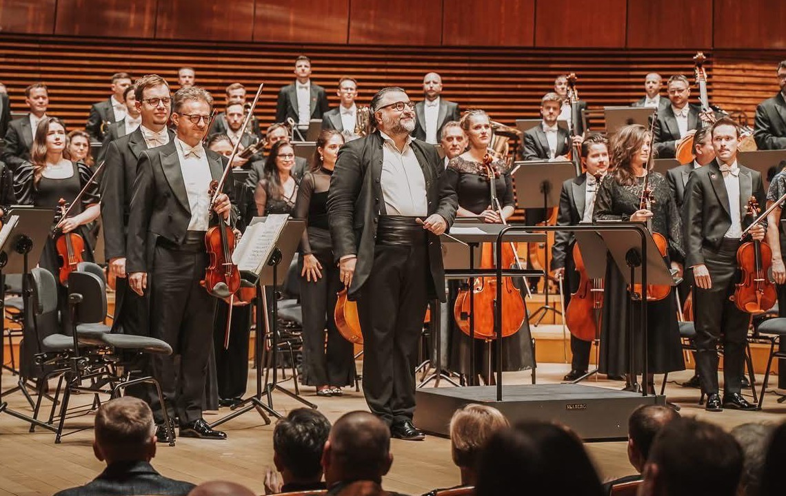 Georgios Balatsinos taking a bow with the orchestra in concert